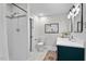 Modern bathroom with dark vanity, white tile shower, and updated fixtures at 2419 Highland Ave, Durham, NC 27704