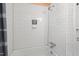 Clean white subway tile shower with a built-in shelf at 2419 Highland Ave, Durham, NC 27704