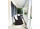 Front porch with rocking chairs, white railing, and dark-colored wicker furniture at 2421 Barton Oaks Drive, Raleigh, NC 27614