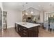 Open kitchen features a large island with seating and flows into the dining area at 2421 Beckwith Rd, Apex, NC 27523