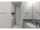 Bathroom with granite countertop, linen closet, and tile floor at 243 New Bern Pl # 301, Raleigh, NC 27601