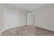 Bedroom with hardwood floors, double closet and access to hallway at 243 New Bern Pl # 301, Raleigh, NC 27601
