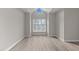 Bedroom with vaulted ceiling and large window at 243 New Bern Pl # 301, Raleigh, NC 27601