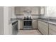Galley kitchen with stainless steel appliances and granite counters at 243 New Bern Pl # 301, Raleigh, NC 27601