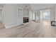 Spacious living room with hardwood floors, fireplace, and sunroom at 243 New Bern Pl # 301, Raleigh, NC 27601