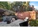 Private backyard patio with brick wall, potted plants and outdoor seating at 255 Penley Cir, Raleigh, NC 27609