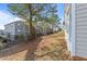 Side view of tan house next to a tree and other houses at 2613 Lilymount Dr, Raleigh, NC 27610