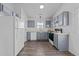 Gray kitchen cabinets, white appliances, and hardwood floors at 2613 Lilymount Dr, Raleigh, NC 27610