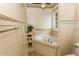 Relaxing bathroom with soaking tub, tile accents, decorative shelving, and neutral color palette at 270 W Silverado Ct, Kenly, NC 27542