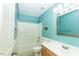 Bright bathroom features a tub/shower combo, blue paint, and a wooden vanity with a sink at 270 W Silverado Ct, Kenly, NC 27542