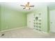 Green-painted bedroom with carpet, ceiling fan, a storage unit, and natural light at 270 W Silverado Ct, Kenly, NC 27542