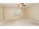 Neutral bedroom with plush carpet, a ceiling fan, and a large window for natural light at 270 W Silverado Ct, Kenly, NC 27542