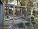 Enclosed chicken coop with a wooden frame, wire mesh, and decorated with planters and foliage at 270 W Silverado Ct, Kenly, NC 27542