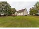 Rear exterior view of home with expansive lawn and wooden deck at 270 W Silverado Ct, Kenly, NC 27542