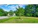 Lush front yard with mature tree and landscaped flower bed at 270 W Silverado Ct, Kenly, NC 27542