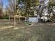 A backyard garden area with raised beds, a small greenhouse, and a storage shed at 270 W Silverado Ct, Kenly, NC 27542