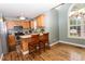 Bright kitchen features stainless steel appliances, light wood cabinets, breakfast bar, and hardwood floors at 270 W Silverado Ct, Kenly, NC 27542