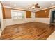 Bright living room boasting hardwood floors, large windows, a ceiling fan, and classic wainscoting at 270 W Silverado Ct, Kenly, NC 27542