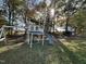 A backyard play structure with a slide, a swing, and a wooded backdrop offers fun for children at 270 W Silverado Ct, Kenly, NC 27542