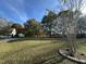 Large front yard of a property with manicured lawn, trees, and ample space at 270 W Silverado Ct, Kenly, NC 27542