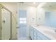 Double vanity bathroom with a large mirror and shower at 308 Johnson Ridge Way, Four Oaks, NC 27524
