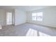Bright bedroom with carpet, an ensuite bathroom and large window at 308 Johnson Ridge Way, Four Oaks, NC 27524