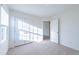 Well-lit bedroom featuring carpet, double door closet, and access to another room at 308 Johnson Ridge Way, Four Oaks, NC 27524