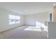 Sunlit bonus room with carpeted floor and large window at 308 Johnson Ridge Way, Four Oaks, NC 27524