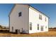 White vinyl sided home with multiple windows and AC unit at 284 Johnson Ridge Way, Four Oaks, NC 27524