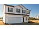 Two story house with white siding, dark brown shutters, and a two car garage at 308 Johnson Ridge Way, Four Oaks, NC 27524