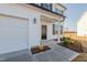 House exterior featuring a covered front porch and black front door at 308 Johnson Ridge Way, Four Oaks, NC 27524