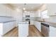 Modern kitchen with white cabinets, granite countertops, and stainless steel appliances at 308 Johnson Ridge Way, Four Oaks, NC 27524