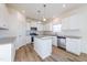 Modern kitchen with island, white cabinets, and stainless steel appliances at 308 Johnson Ridge Way, Four Oaks, NC 27524