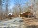 Property view shows home, detached workshop, and wooded surroundings at 2901 Shagbark Ln, Graham, NC 27253