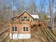 Two-story A-frame home with wrap-around deck and wooded views at 2901 Shagbark Ln, Graham, NC 27253