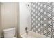 Bathroom with shower/tub combo and geometric patterned wall at 307 N Hyde Park Ave, Durham, NC 27703