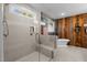 Modern bathroom with a large glass shower, soaking tub, and rustic wood accents at 40 Yellowstone Ct, Youngsville, NC 27596