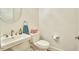 Small bathroom with toilet, sink, and round mirror at 4034 S Mcdowell, Pittsboro, NC 27312