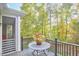 Deck overlooking wooded backyard with table and chairs at 4034 S Mcdowell, Pittsboro, NC 27312