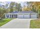 Gray house with a three-car garage and a long driveway at 4034 S Mcdowell, Pittsboro, NC 27312