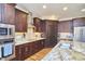 Modern kitchen featuring stainless steel appliances and dark wood cabinetry at 4034 S Mcdowell, Pittsboro, NC 27312