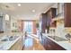 Open kitchen with island, hardwood floors, and view to living area at 4034 S Mcdowell, Pittsboro, NC 27312