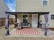 Relaxing patio with covered seating area and grill at 4236 Amber Stone Way, Durham, NC 27704