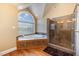 Spa-like bathroom with a soaking tub and walk-in shower at 430 Federal Rd, Benson, NC 27504