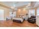 Bright bedroom with hardwood floors, built-in desk and a relaxing recliner at 430 Federal Rd, Benson, NC 27504