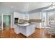 Spacious kitchen with granite island, stainless steel appliances, and hardwood floors at 430 Federal Rd, Benson, NC 27504