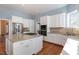 Bright kitchen featuring white cabinets, granite countertops, and stainless steel appliances at 430 Federal Rd, Benson, NC 27504