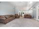 Spacious living room featuring plush furniture, neutral carpet, and an open layout into the adjacent kitchen at 430 Federal Rd, Benson, NC 27504