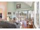 Bright living room featuring hardwood floors, large windows, and a grand piano at 430 Federal Rd, Benson, NC 27504