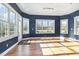 Bright sunroom with hardwood floors and multiple windows at 430 Federal Rd, Benson, NC 27504